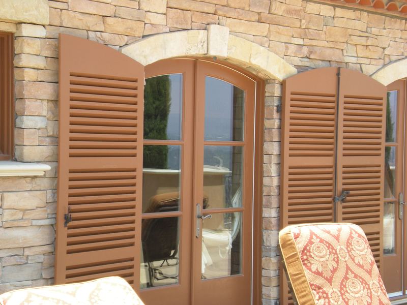 Custom wood shutters and stone arch detail