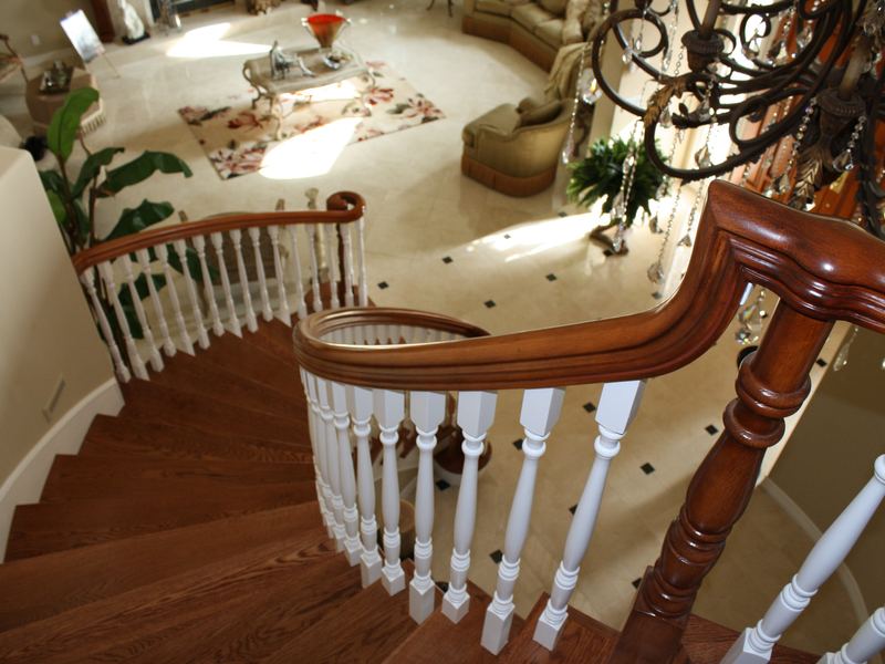 Curved hardwood staircase with turned balusters