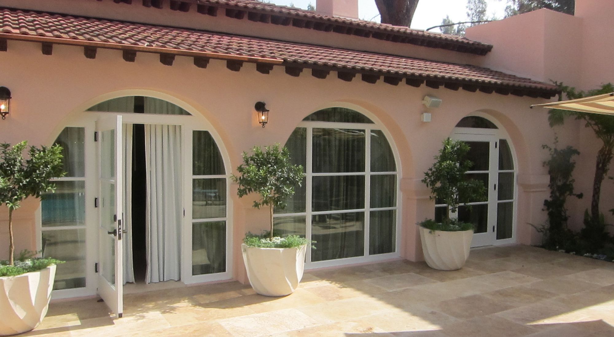 Custom designed arched doors and windows on a Mediterranean residence