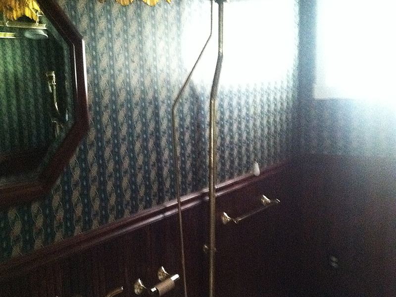 Restored bathroom with period tile and papering