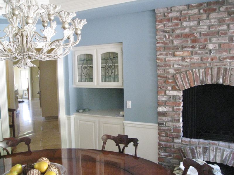 Living room with brick fireplace and custom cabinetry